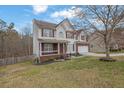 Charming two-story home with a well-manicured front yard, complemented by mature trees at 1514 Log Cabin Ln, Lawrenceville, GA 30045