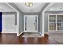 Inviting foyer with hardwood floors, neutral gray walls, white trim, and natural light from sidelight windows at 1514 Log Cabin Ln, Lawrenceville, GA 30045