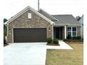 Beautiful one story home with a brick facade, attached garage, and well-maintained front yard at 1769 Rowland Pass, Buford, GA 30518