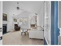 Bright living room featuring vaulted ceilings, fireplace, and large windows at 1905 Cottage Grove Way, Cumming, GA 30040