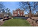 Charming two-story brick home with a manicured lawn and mature landscaping at 491 Lees Sw Trce, Marietta, GA 30064