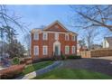 Charming two-story brick home with a manicured lawn and a welcoming entrance at 491 Lees Sw Trce, Marietta, GA 30064