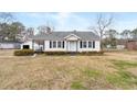 Classic single-story home with a tidy lawn and a detached garage at 116 Poplar St, Fairburn, GA 30213