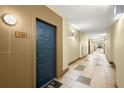 Neutral hallway featuring tiled floors, baseboards, and door to unit 1304 at 400 17Th Street Nw # 1304, Atlanta, GA 30363