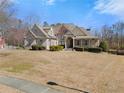 Beautiful home with a manicured lawn, covered entrance and symmetrical design under a blue sky at 1348 Ewing Creek Dr, Dacula, GA 30019
