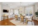 Elegant dining room featuring a chandelier, large window, and hardwood floors at 1205 New Haven Ct, Roswell, GA 30075