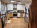 Kitchen featuring stainless steel appliances, granite counters, and custom cabinets at 2820 Bluebird Cir, Duluth, GA 30096