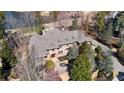 Expansive home featuring a stone exterior, prominent roof dormers and professional landscaping near a lakeside golf course at 939 Middle Fork Trl, Suwanee, GA 30024
