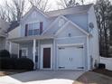 View of the front of a home with gray siding, dark shutters, and an attached one car garage at 235 Woodland Way, Canton, GA 30114