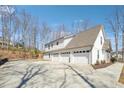 Three-car garage offers ample parking and storage, with a large concrete driveway for easy access at 40 Oak Forest Dr, Oxford, GA 30054
