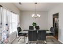 Bright dining room with a glass table, seating for six, and large window at 5729 Newnan Cir, Austell, GA 30106