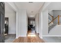 Inviting foyer featuring hardwood floors, staircase, and a view to the living room at 5729 Newnan Cir, Austell, GA 30106
