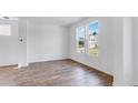 Bright living room featuring wood floors, white walls, and large windows at 201 Groveton Ct, Euharlee, GA 30145