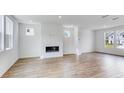Open-concept living space with hardwood floors and a sleek, built-in fireplace at 201 Groveton Ct, Euharlee, GA 30145