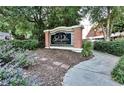 Elegant brick condominium community sign surrounded by lush landscaping and walking path at 375 Ralph Mcgill Blvd # 601, Atlanta, GA 30312