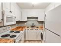 Cozy kitchen featuring white cabinets, butcher block countertops, and modern appliances at 375 Ralph Mcgill Blvd # 601, Atlanta, GA 30312