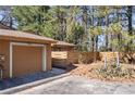 Exterior of house with a tan garage and a partial view of the yard at 841 Lake Hollow Sw Blvd, Marietta, GA 30064