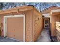 A close-up view of the garage and front door with tan-colored shingles at 841 Lake Hollow Sw Blvd, Marietta, GA 30064