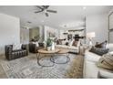 Expansive living room with stylish furnishings, including leather chairs, plush sofas, and a decorative rug at 205 Delilah St, Mcdonough, GA 30252