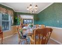 Charming dining room with hardwood table, seating for six, and decorative chandelier at 210 Meadow View Dr, Grayson, GA 30017