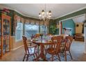 Inviting dining room with chandelier, large window, and classic wooden dining set at 210 Meadow View Dr, Grayson, GA 30017