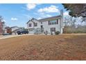 Two-story home with vinyl siding, attached garage, and large yard with mature tree coverage at 210 Meadow View Dr, Grayson, GA 30017