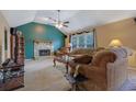 Cozy living room features a stone fireplace, ceiling fan, and plush seating with a high ceiling at 210 Meadow View Dr, Grayson, GA 30017