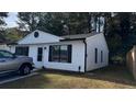 Lovely house with white siding, black trim, a well-maintained lawn, and a concrete driveway at 4778 Pebble Trce, Buford, GA 30518