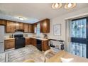 Functional kitchen featuring wooden cabinets, black appliances, and modern tile flooring at 11111 Shannon Cir, Hampton, GA 30228