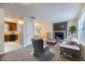 Inviting living room featuring a stone fireplace, plush carpet, and neutral decor at 11111 Shannon Cir, Hampton, GA 30228