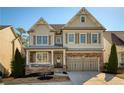 Charming two-story home with stone accents, a welcoming porch, and a well-manicured front yard at 1760 Grand Oaks Drive, Woodstock, GA 30188