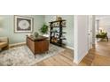 Stylish home office featuring a decorative desk, open shelving, and soothing green walls, perfect for a productive workspace at 465 Madison Lakeview Dr, Acworth, GA 30102