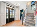 Bright foyer with hardwood floors, grand staircase, and ample natural light, creating a welcoming entry at 3132 Skyland Ne Dr, Atlanta, GA 30341