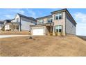 Well-kept, two-story house with brick details, and green grass; situated on a manicured lawn at 4779 Mock Orange Sw St, Atlanta, GA 30331