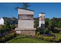 Laurelwood Community sign featuring a stone entrance and colorful landscaping at 1115 Lockhart Way, Douglasville, GA 30135