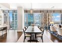 Elegant dining room with hardwood floors, floor to ceiling windows, and seating for eight at 1065 Peachtree Ne St # 3105, Atlanta, GA 30309