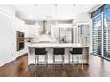 Modern white kitchen with stainless steel appliances, center island, and city view at 1065 Peachtree Ne St # 3105, Atlanta, GA 30309