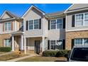 Attractive townhome with complementary siding, shutters, manicured landscaping, and inviting curb appeal at 2258 Bigwood Trail Trl, Atlanta, GA 30349