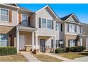 Attractive townhome with complementary siding, shutters, manicured landscaping, and inviting curb appeal at 2258 Bigwood Trail Trl, Atlanta, GA 30349