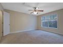 Bright bedroom with carpet, ceiling fan, and large window bringing in natural light, creating a welcoming space at 4206 Santa Fe Pkwy, Atlanta, GA 30350