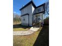 Charming two-story home with light blue siding, a walkway, and a well-manicured lawn at 900 Ira Sw St, Atlanta, GA 30310