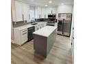 Well-equipped kitchen with stainless steel appliances, an island, and white cabinetry at 900 Ira Sw St, Atlanta, GA 30310