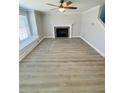 Spacious living room featuring a fireplace, a large window, and modern flooring at 900 Ira Sw St, Atlanta, GA 30310