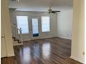 Bright living room boasting beautiful wood floors, large windows, and a stylish ceiling fan at 3133 West Point Cir, Douglasville, GA 30134