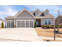Charming exterior view showcasing a well-maintained lawn and inviting facade with a prominent three-car garage at 505 Windy Ridge Ct, Canton, GA 30114