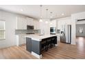 Modern kitchen with island, stainless steel appliances, and white cabinets at 505 Windy Ridge Ct, Canton, GA 30114
