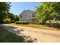 Spacious two-story home with large front yard and lush trees providing shade at 215 Odyssey Turn, Conyers, GA 30012