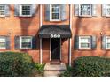 Inviting apartment entrance with a stylish black awning and well-maintained brick facade at 560 Goldsboro Ne Rd # C, Atlanta, GA 30307