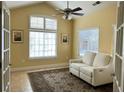 Bright living room featuring comfortable seating, a ceiling fan, and french doors at 120 Chastain Nw Rd # 1803, Kennesaw, GA 30144