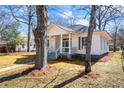 Renovated single story home with fresh exterior paint and manicured lawn with mature shade trees at 34 N Broad N St, Porterdale, GA 30014